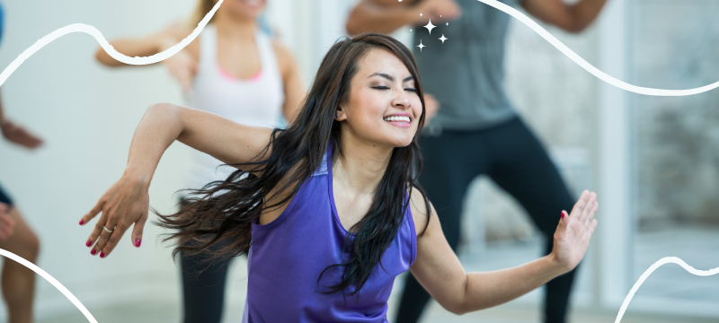 Woman in purple top & long black hair dances with eyes closed