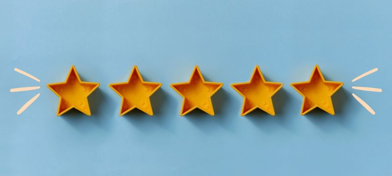 5 yellow toy stars in a row with illustrated spiky lines on either side